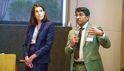 QSI RENU faculty members Jacqueline Burke and Satish Nadig speak to the audience during the Institute's launch event in April 2025.