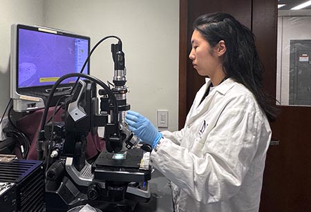 Jamin Lee viewing materials under a microscope