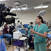 Jacqueline Burke speaking to a WGN reporter about her work to rehabilitate donor livers.